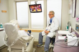 Dr. Ed White, DDS with a patient.